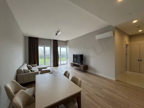 Bright and spacious living room interior decorated with modern furniture.