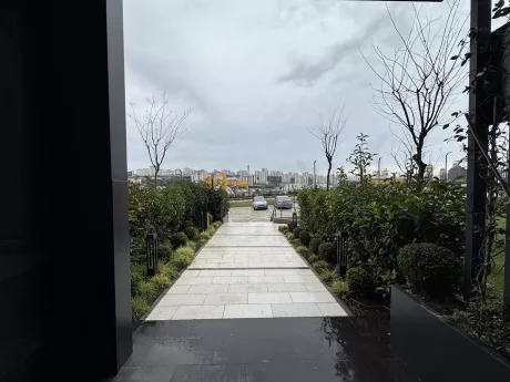 Controlled security gate and barrier system at the entrance of a modern residential complex.