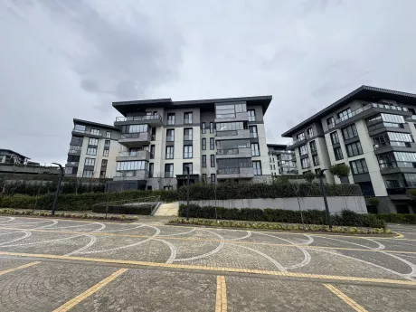 Spacious, bright, and organized indoor parking area of a modern residential complex.