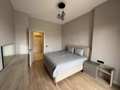 A spacious and bright bedroom with modern decoration.