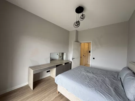 A spacious and bright furnished bedroom design decorated with modern furniture.