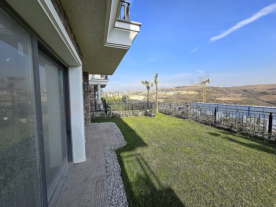 Photograph of a villa with a large garden.