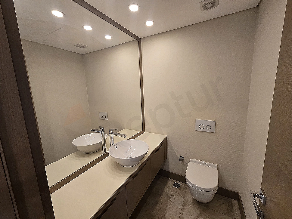 Image of a modern designed duplex apartment bathroom with luxurious details. White ceramics, large shower cabin, and stylish lighting.