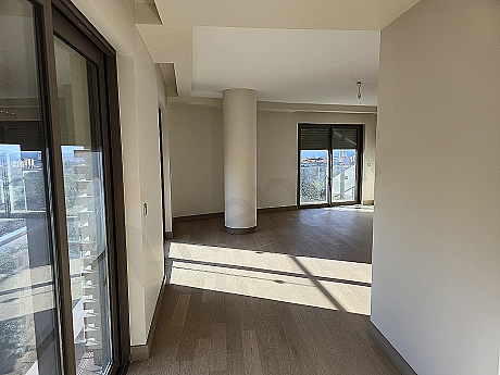 Stylish and modern bedroom interior, featuring a large double bed, wooden bedside tables, lamps, curtain and carpet detail