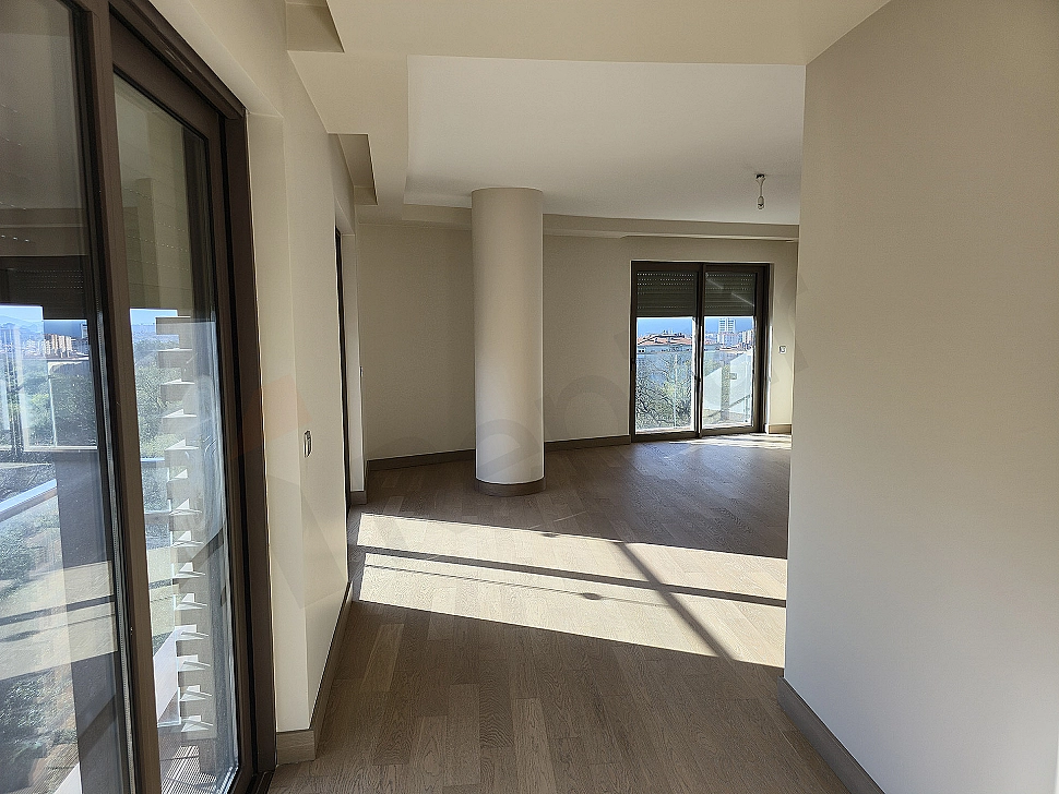 Stylish and modern bedroom interior, featuring a large double bed, wooden bedside tables, lamps, curtain and carpet detail