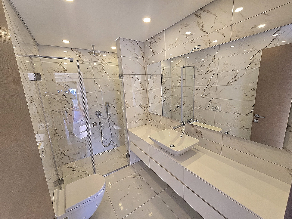 Modern designed, spacious and bright duplex apartment bathroom. Luxury fixtures and ceramic details.