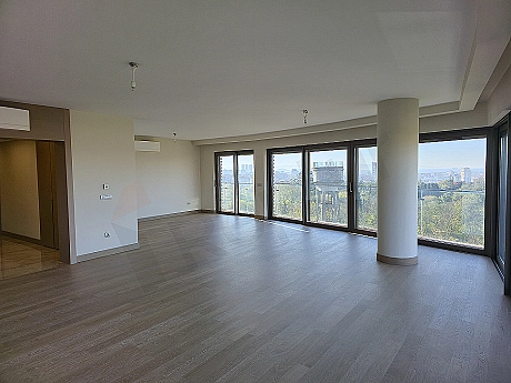 Modernly designed living room interior, large windows, stylish furniture, and bright atmosphere.