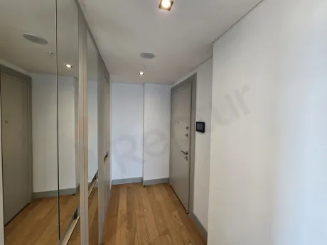 Spacious, bright, and minimalist designed hallway of a modern apartment.