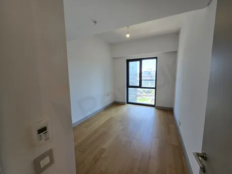 A spacious and bright bedroom with modern architecture and large windows.