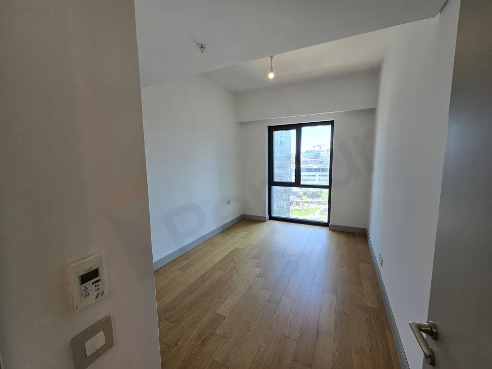 A spacious and bright bedroom with modern architecture and large windows.