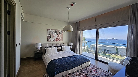 Spacious and bright modern villa bedroom design with large windows.