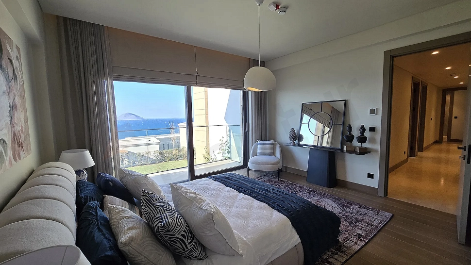 View of a spacious and bright villa bedroom with modern architecture.