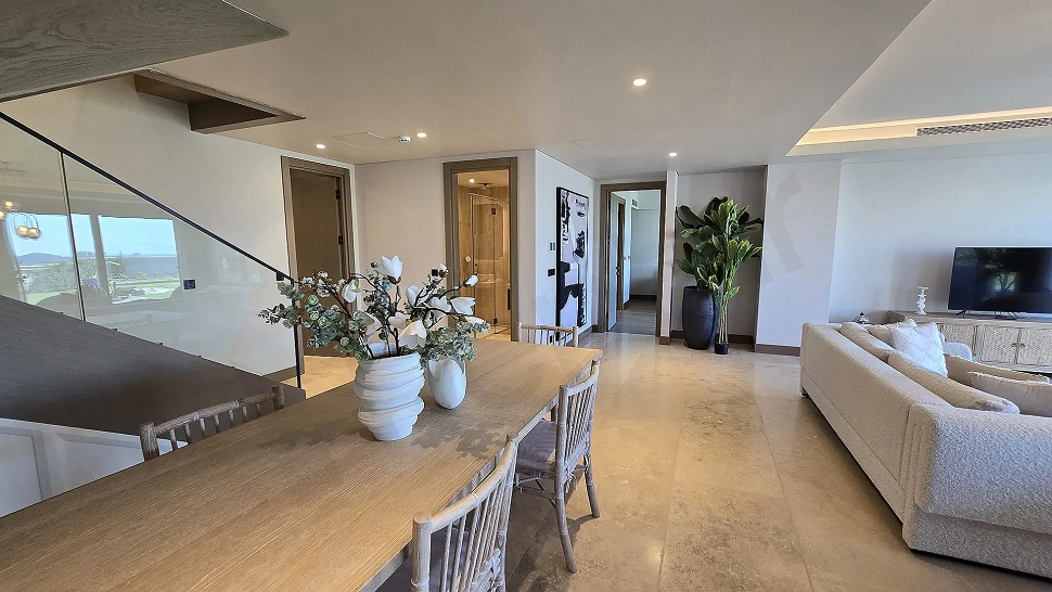 Modernly designed, spacious dining room area with large windows.