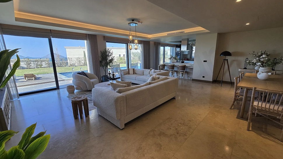 A spacious and bright living room area of a modern villa with architectural details.