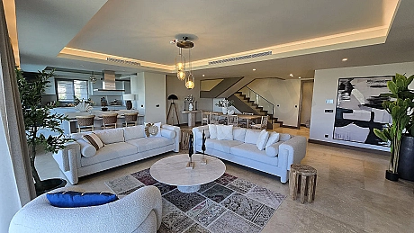 Spacious and bright modern living room area with large windows in a luxury seafront villa in Bodrum.