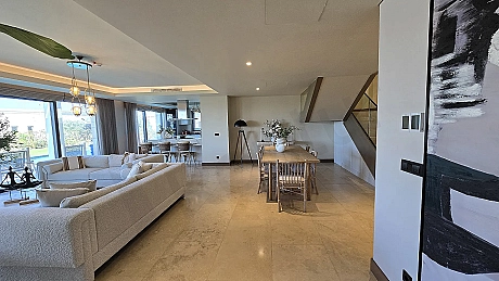 Spacious and bright living room area with modern architecture and large windows.