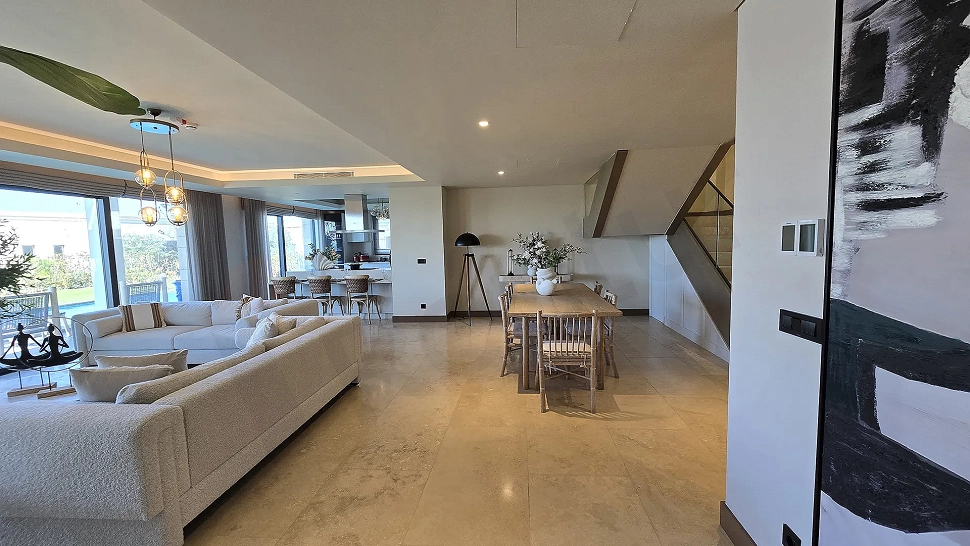 Spacious and bright living room area with modern architecture and large windows.