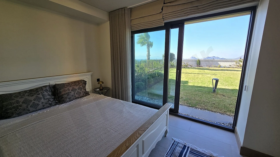 Spacious and bright luxury villa bedroom with modern design and large windows.