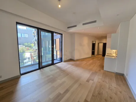 Modernly designed, spacious dining room area with large windows.