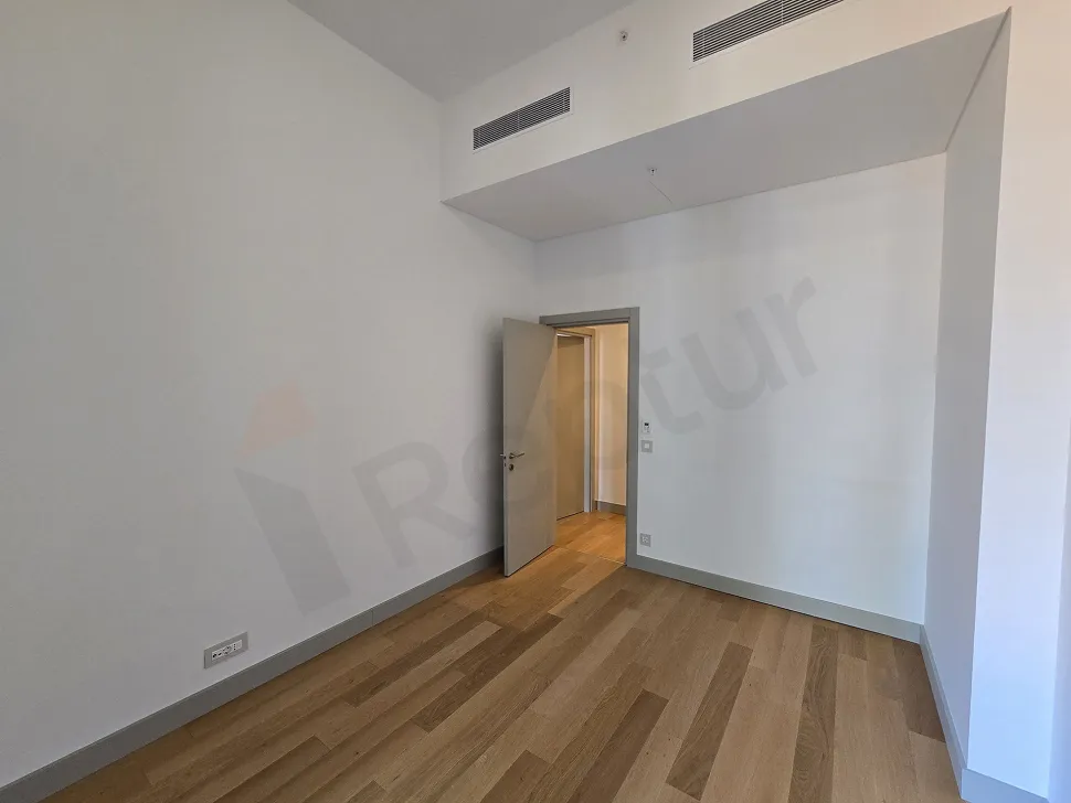View of a spacious and bright bedroom in a modern residence project.