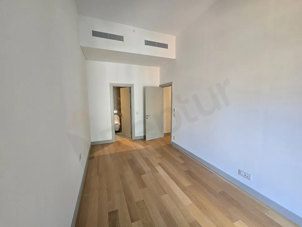 Spacious and bright bedroom interior of a modern residence apartment.