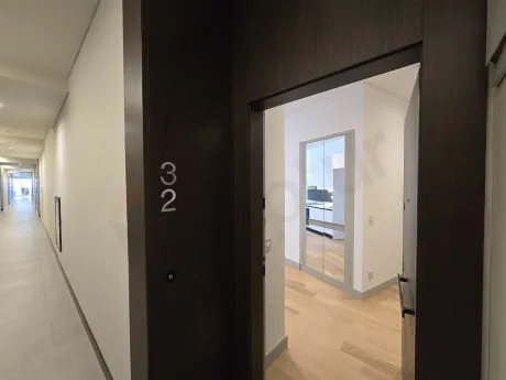 Entrance hall and front door view of a modern apartment.