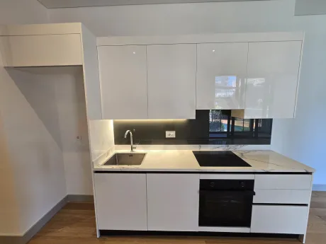 Sleek and modern kitchen area of a spacious premium residence apartment.