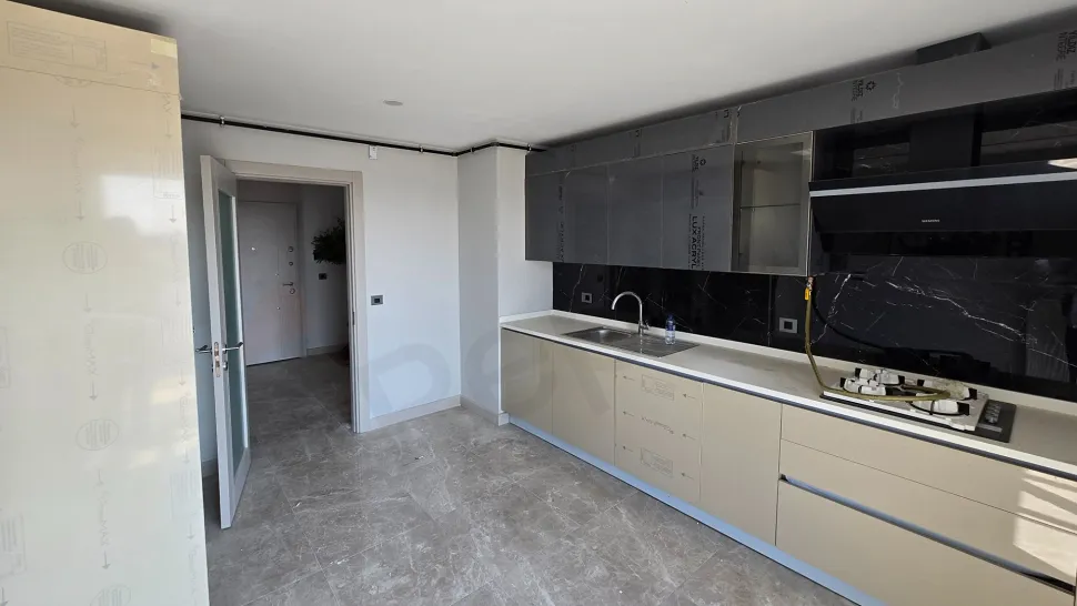 A modern and spacious kitchen area with large countertops and functional cabinet designs.
