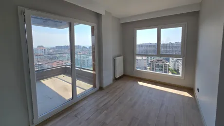 Spacious and modern design bedroom of a 5+1 duplex apartment for sale in Beylikduzu, Istanbul with city views.