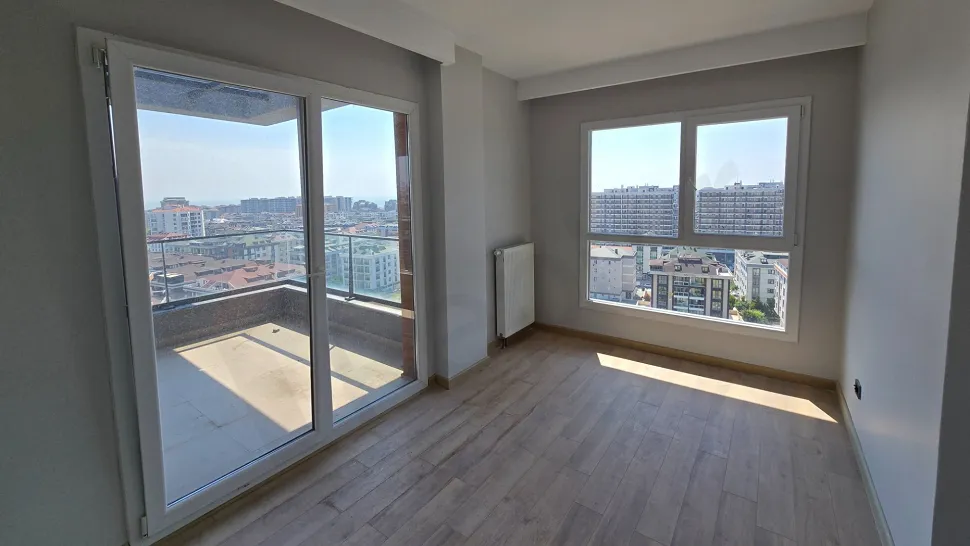 Spacious and modern design bedroom of a 5+1 duplex apartment for sale in Beylikduzu, Istanbul with city views.