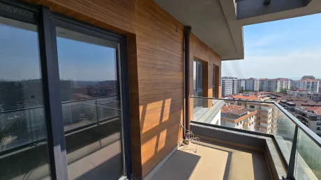 Modern and spacious balcony of a duplex apartment with a city view.