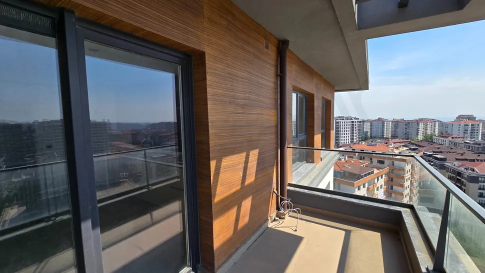 Modern and spacious balcony of a duplex apartment with a city view.