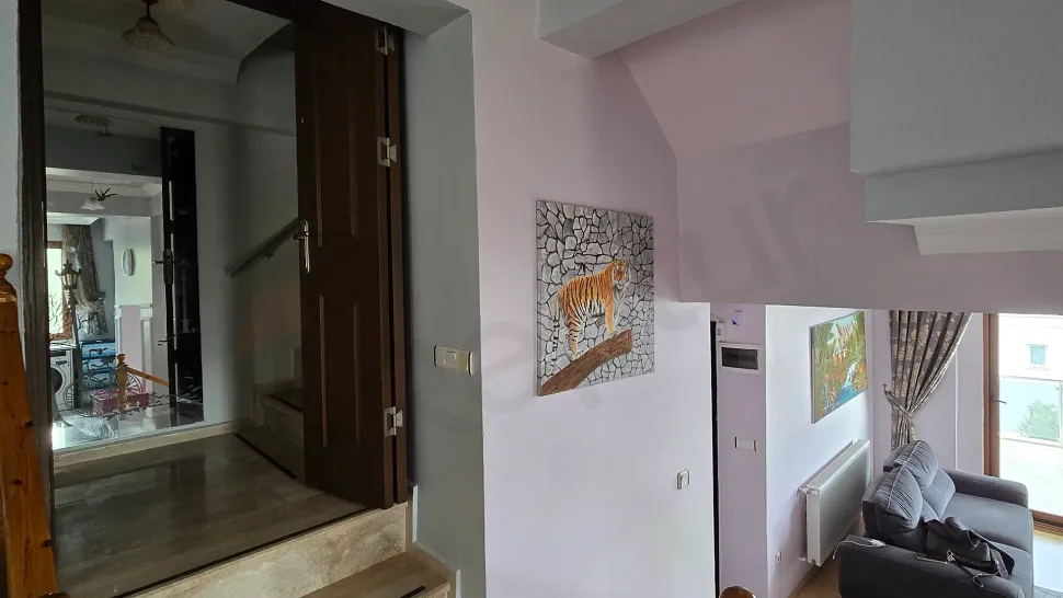 Spacious and bright corridor of a modern duplex apartment.