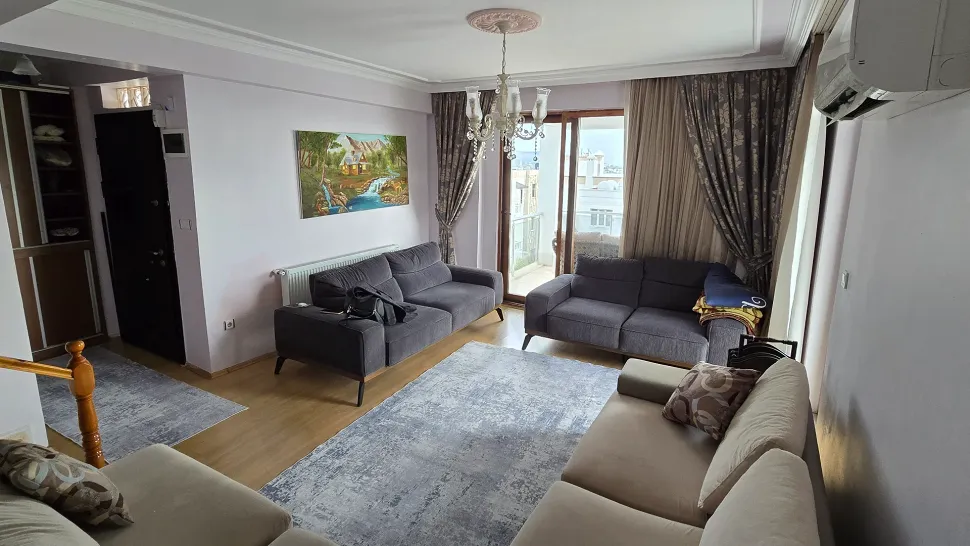 A spacious and bright living room with modern design and large windows capturing natural light.