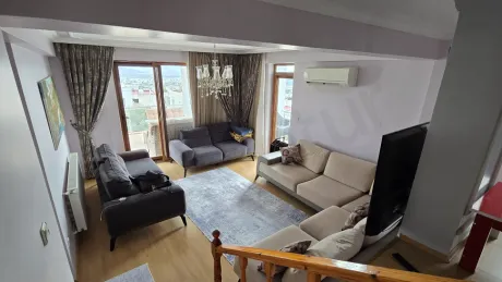 Spacious and bright living room area of a duplex apartment with sea view in Bodrum.