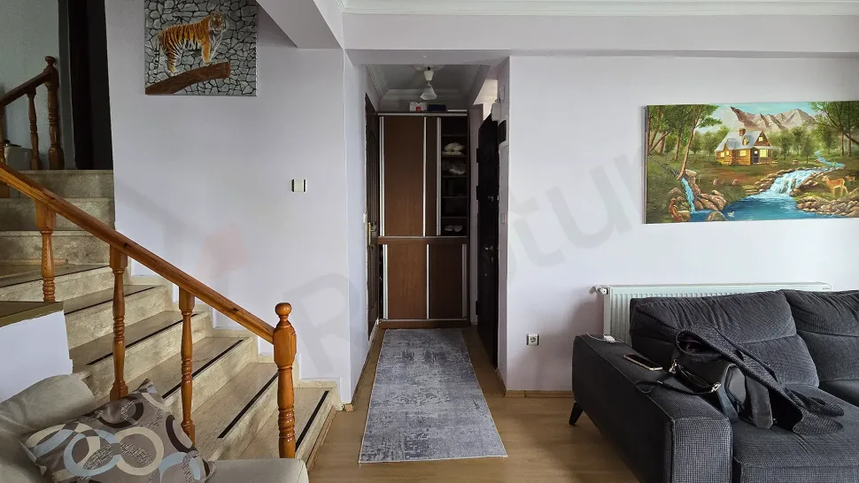 Spacious and bright corridor area of a modern residence.