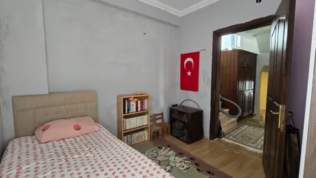 Spacious and bright bedroom of a 3+1 duplex apartment for sale in Bodrum.