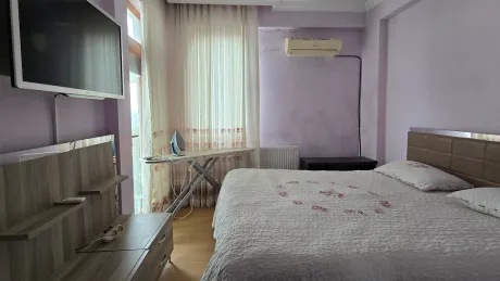 Image of a spacious and sunlit bedroom in a duplex apartment with a sea view in Bodrum.