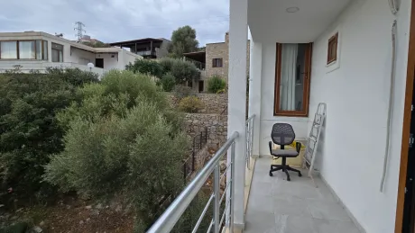 Exterior view of a spacious and modern balcony with a sea view.