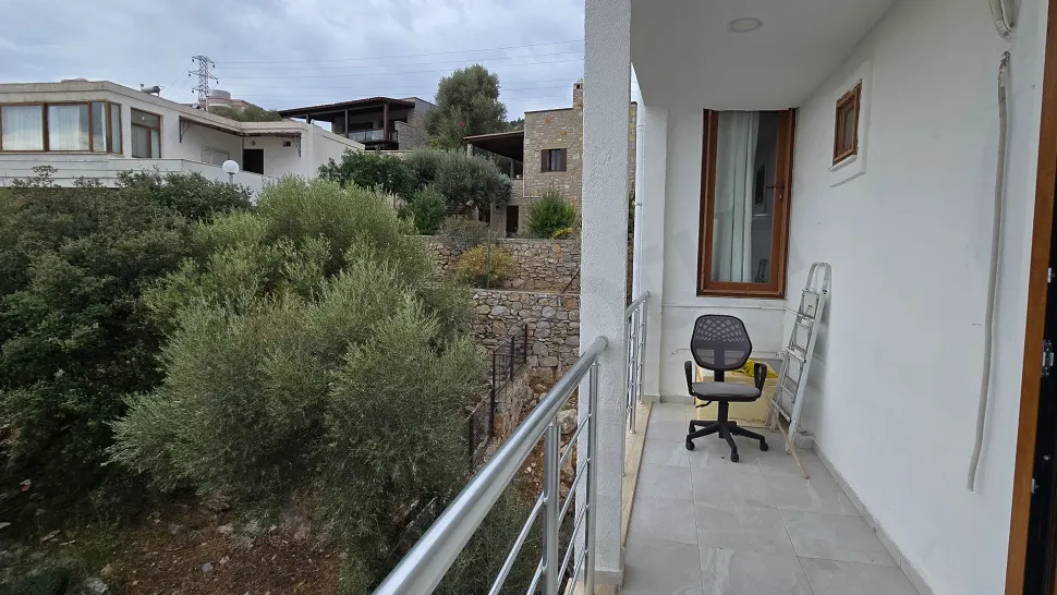 Exterior view of a spacious and modern balcony with a sea view.