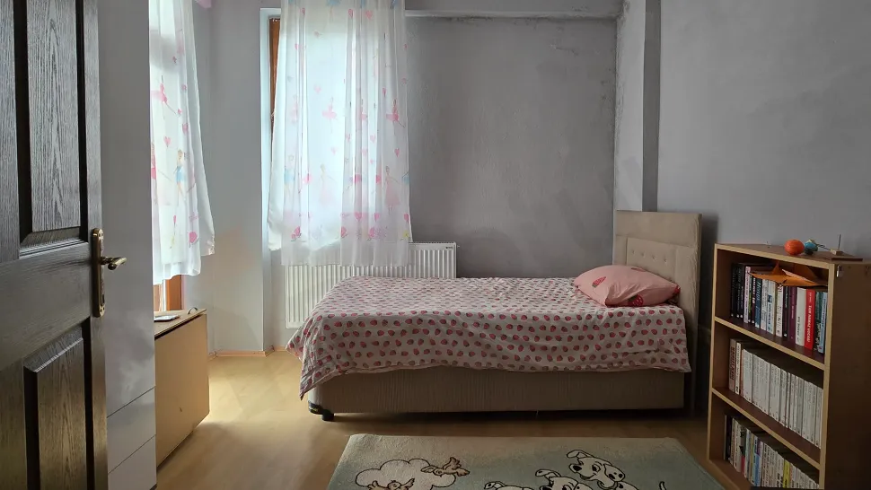 Spacious and bright bedroom interior view.