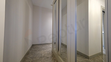 Interior view of a furnished apartment corridor.