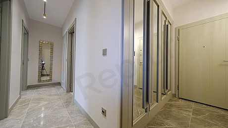 Interior view of furnished apartment corridor.