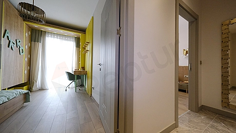 Interior view of a furnished apartment corridor.