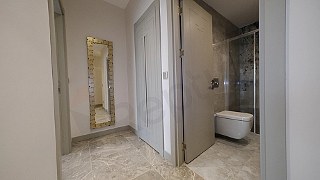 Interior view of furnished apartment corridor.