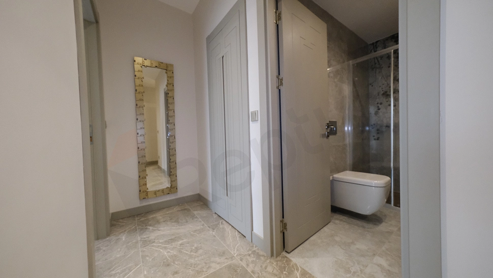 Interior view of furnished apartment corridor.