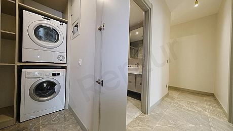 Interior view of a furnished apartment corridor.