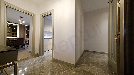 Interior view of a furnished apartment corridor.