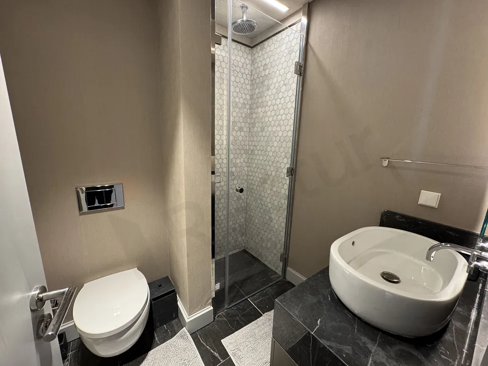 Modern and stylishly detailed bathroom of a furnished 2+1 apartment in Şişli.