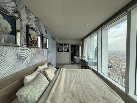 View of a spacious and bright bedroom decorated with stylish and modern furniture in Sisli.